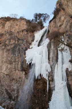 Falls in the snow in the autumn. Kegety canyon in Asia, Kyrgyzstan clipart