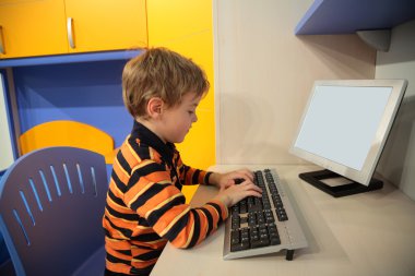 Boy at computer in children's room clipart