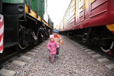 Two children between trains clipart