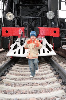 Boy runs before locomotive clipart