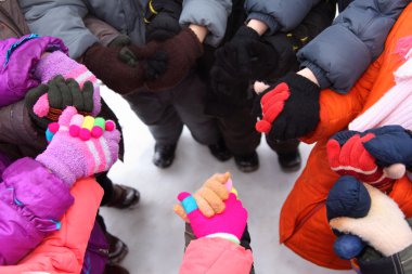 Children stand around having joined hands, top view clipart