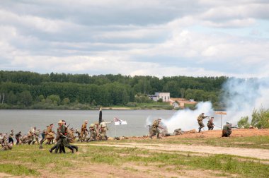 LAKE SENEJ, RUSSIA - MAY 30, 2008: Soldiers in attack in a WWI r clipart