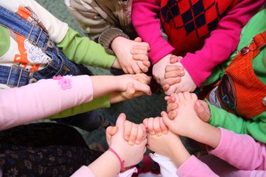 Children stand having joined hands, top view clipart