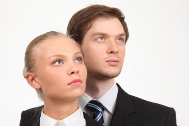 Young business woman and businessman look upward clipart