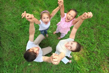 Parents with children stand having joined hands and having lifte clipart