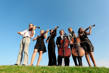 Six musicians play violins against sky clipart