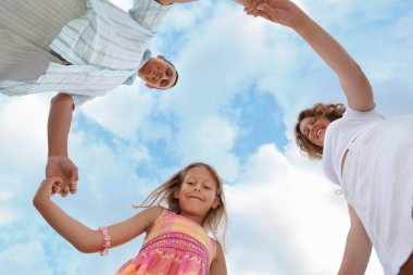 Happy family with little girl against sky, foreshortening from b clipart