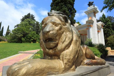 Statue of lion in Sochi arboretum clipart