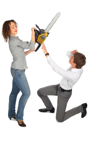Young man is protected from girl with chain saw — Stock Photo, Image