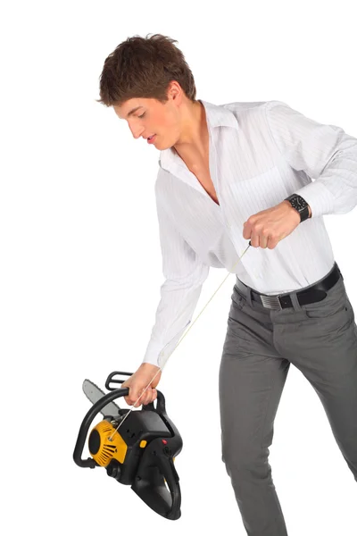 Young man starts chainsaw — Stock Photo, Image