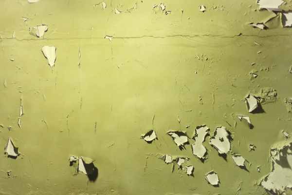Wall with peeled off green paint