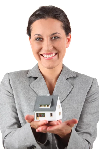 Businesswoman holding home — Stock Photo, Image