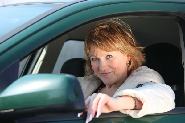 Middleaged woman in car — Stock Photo, Image