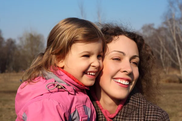 Mor med lilla dotter på händer utomhus under våren — Stockfoto