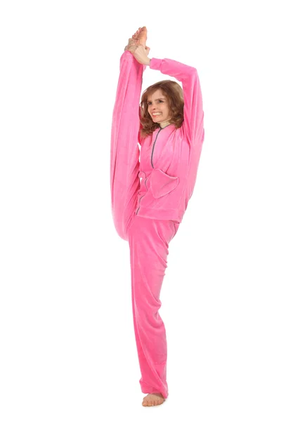 Girl in pink clothes holds leg vertically upwards — Stock Photo, Image