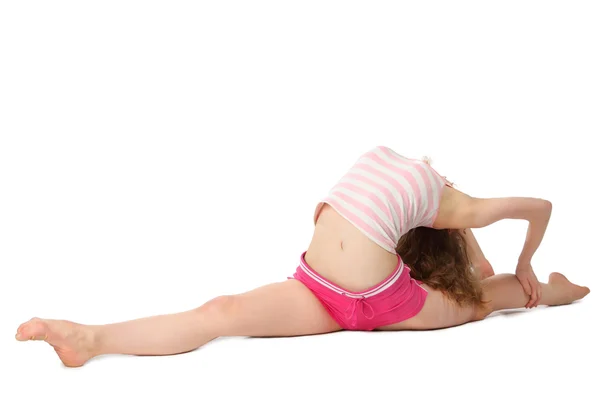 Chica en ropa deportiva hace ejercicio gimnástico en el suelo —  Fotos de Stock