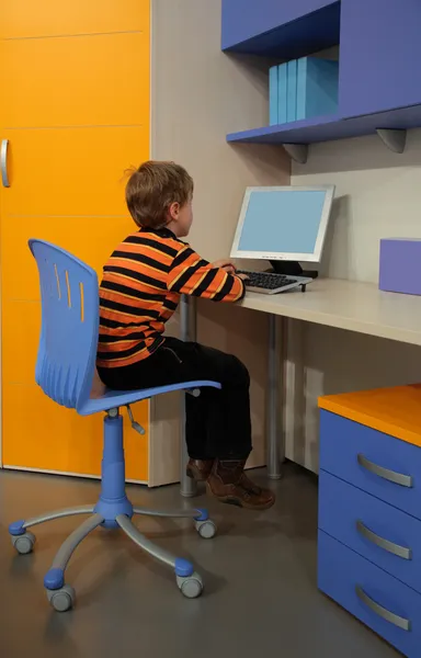Хлопчик за комп'ютером в дитячій кімнаті — стокове фото