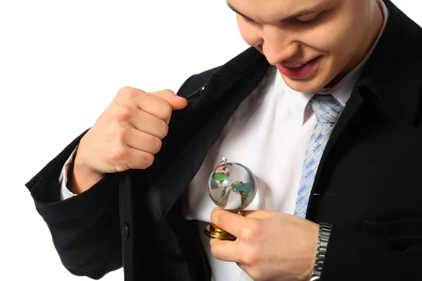 Mladý podnikatel se sklem koule v ruce — Stock fotografie