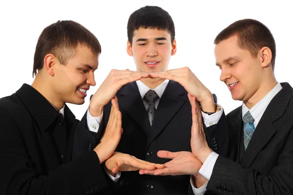 Three young businessmen do house from palms — Stock Photo, Image