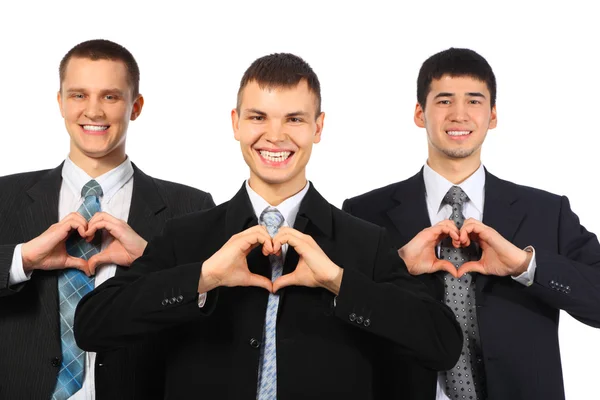 Três jovens empresários sorridentes mostram sinal de amor das mãos — Fotografia de Stock