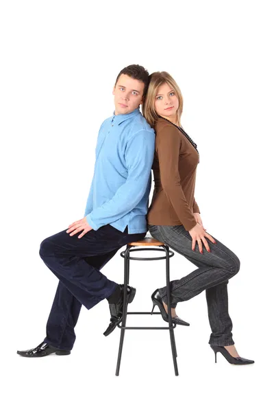 Couple sits on bar stool back to back — Stock Photo, Image