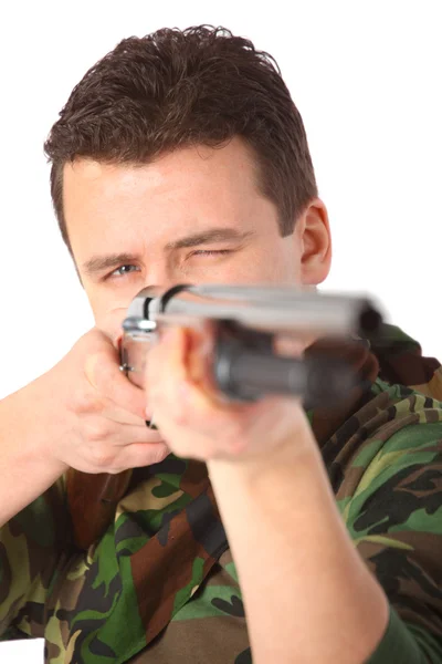 Man in camouflage pointed from gun — Stock Photo, Image