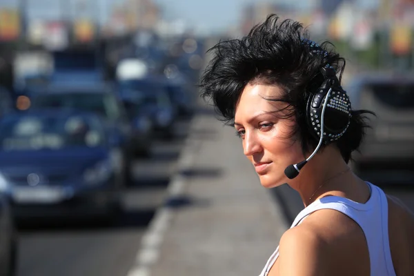 Girl in headphone set on highway middle — Stock Photo, Image
