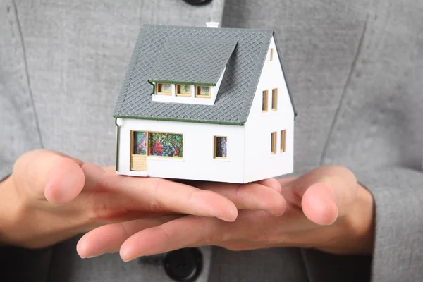 Hands with model of house — Stock Photo, Image