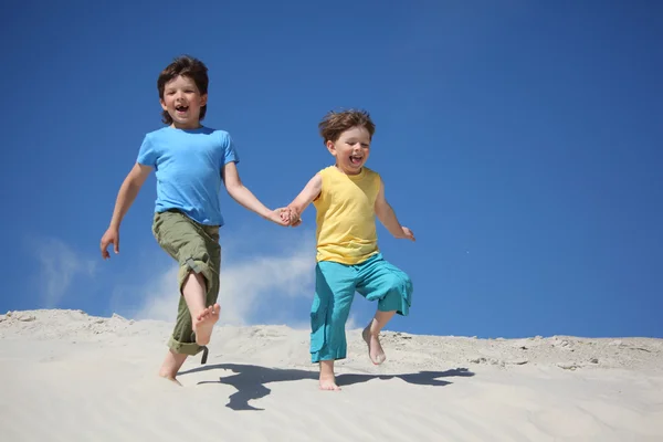 Два мальчика бегают по песку — стоковое фото
