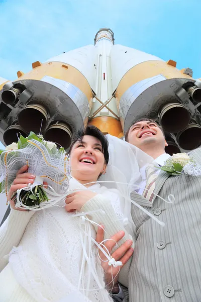 Space rocket over fiance and bride — Stock Photo, Image