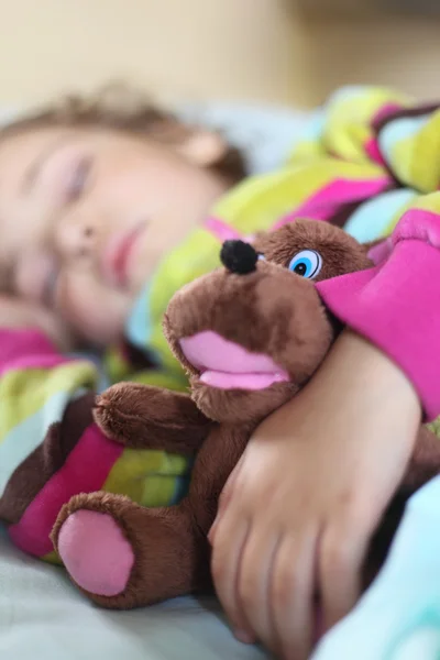 Little girl sleeps in train with puppet — Stock Photo, Image
