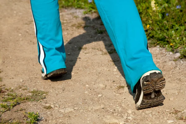 Feet of young woman jogging in the country — Stock Photo, Image