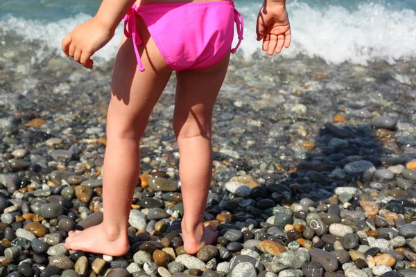 Children's feet on seacoast — Stock Photo, Image