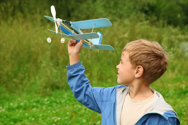 stock image Boy with toy airplane in hands outdoor