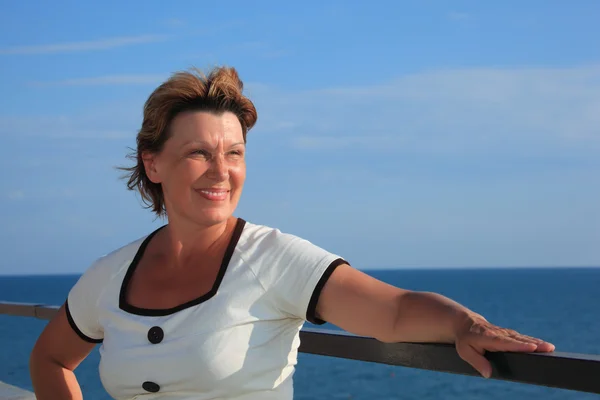 Porträt einer Frau mittleren Alters auf dem Balkon über dem Meer — Stockfoto