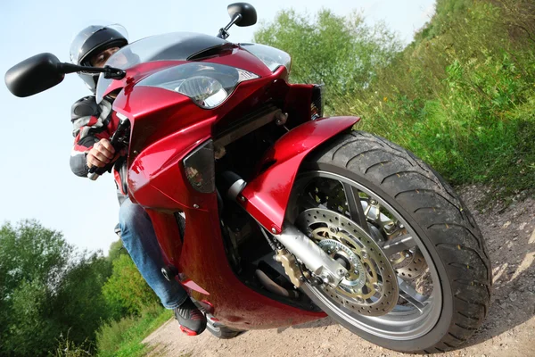 Motorcyclist standing on country road, bottom view — Stock Photo, Image