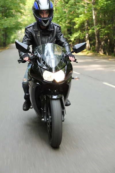 Motorcyclist goes on road, front view — Stock Photo, Image