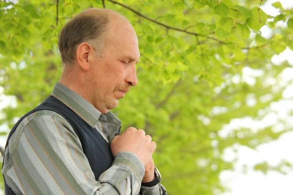 Portrait of middle-aged praying man outdoor — Stock Photo, Image
