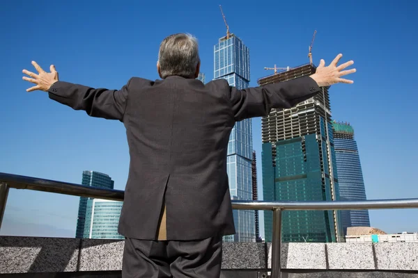 Behind Senior man at the building with hand up — Stock Photo, Image