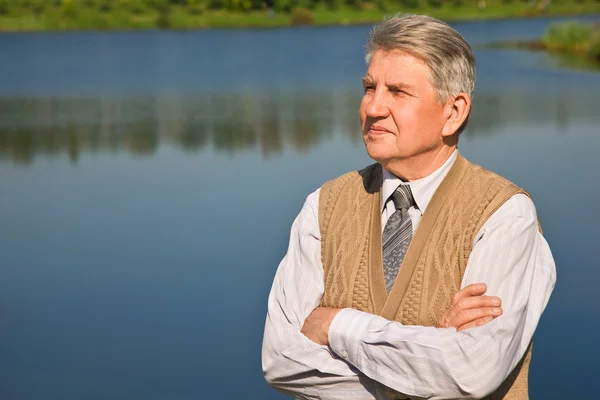 Senior man by the river — Stock Photo, Image