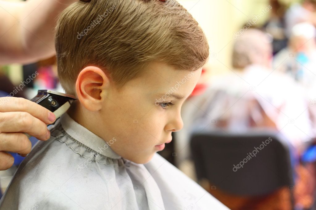 Boy cut in hairdresser's machine