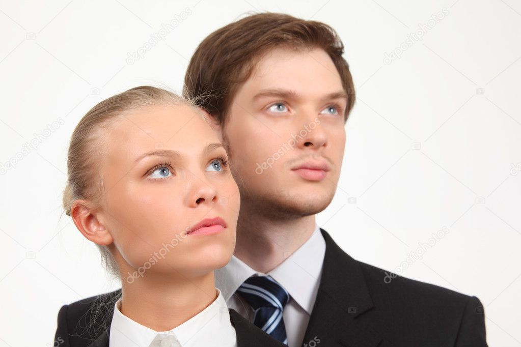 Young business woman and businessman look upward
