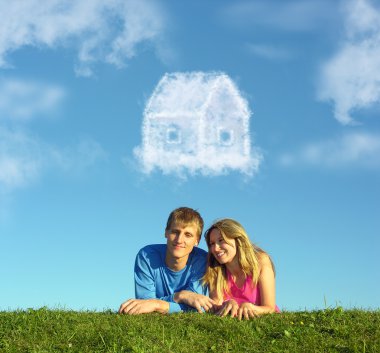 Smiling couple on grass and dream cloud house collage clipart
