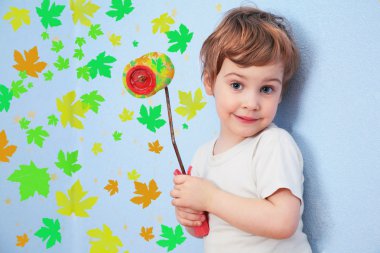 A girl with a roller does repair with leaves, collage