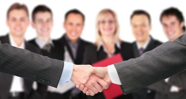 Shaking hands with wrists and six business group out of focus co clipart