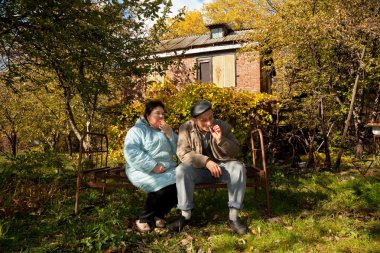 Middleaged man and woman with apples clipart