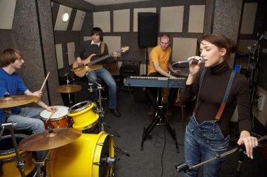 Rock band is working in studio clipart