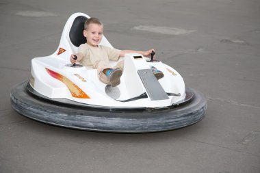 Boy on toy car clipart