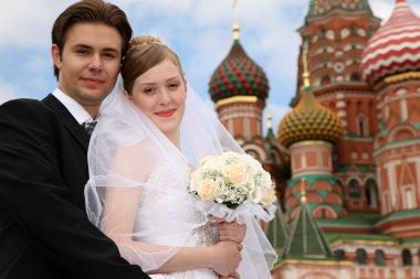 Bride, fiance and St.Basil cathedral clipart