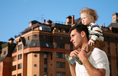 Child on the shoulders of the father clipart